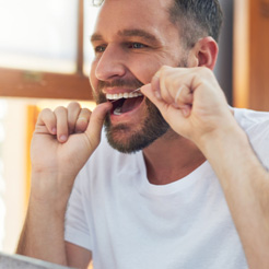 Invisalign patient in Barker Road Brookfield flossing