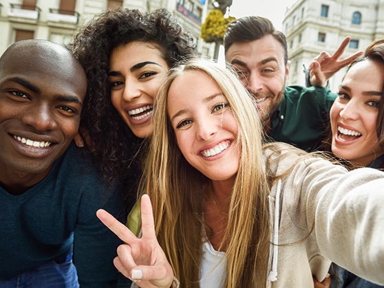 Group of young friends smiling while wearing Invisalign in Wauwatosa